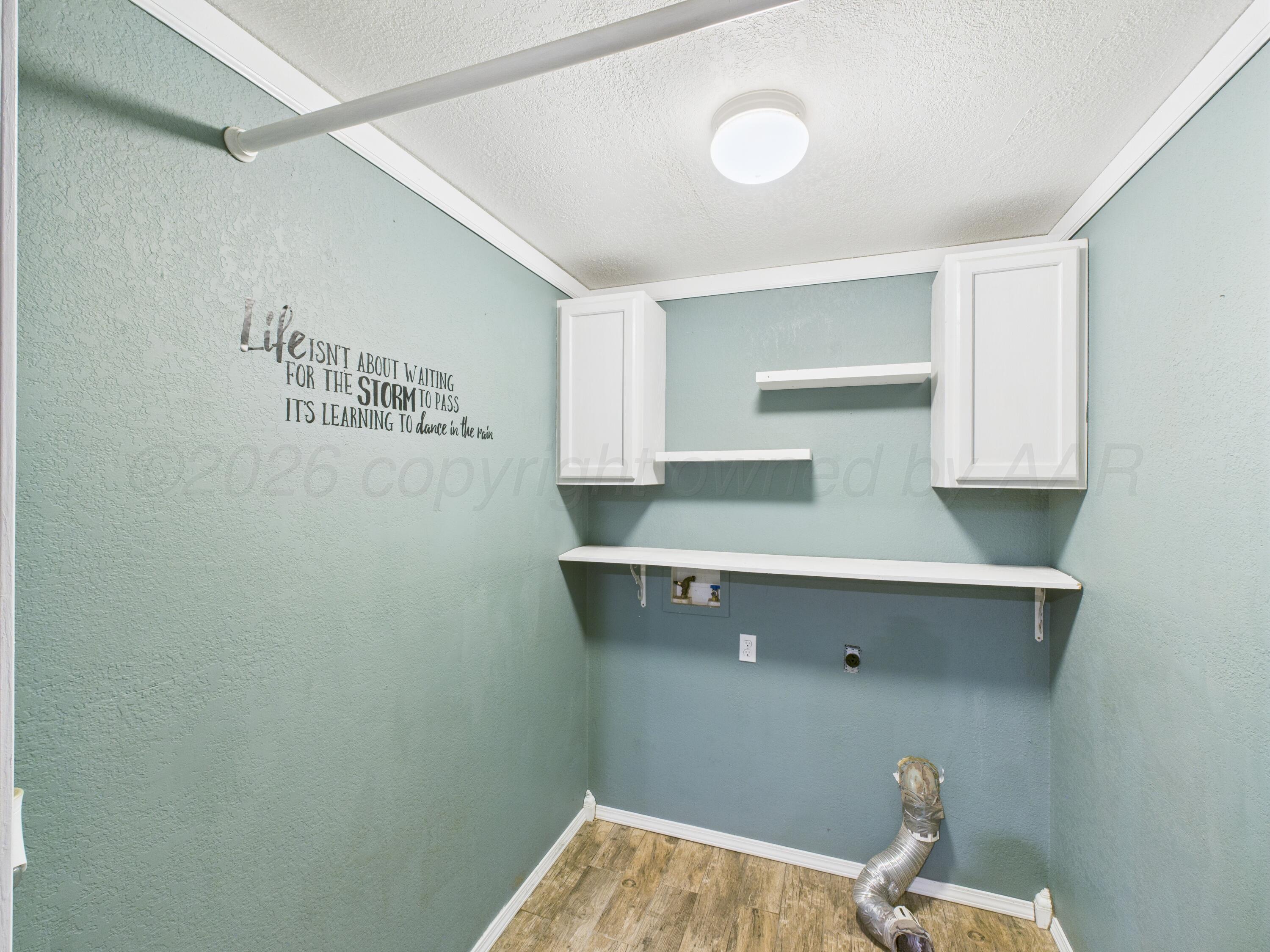 505 South Ridgeland Avenue Fritch, TX 79036 - Photo 3 of 15 a room with cabinets