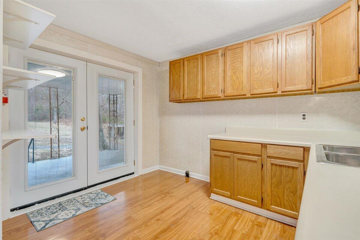 1115 Morgans Mill Road Goodview, VA 24095 - Photo 24 of 50 a view of a kitchen with wooden floor and cabinet