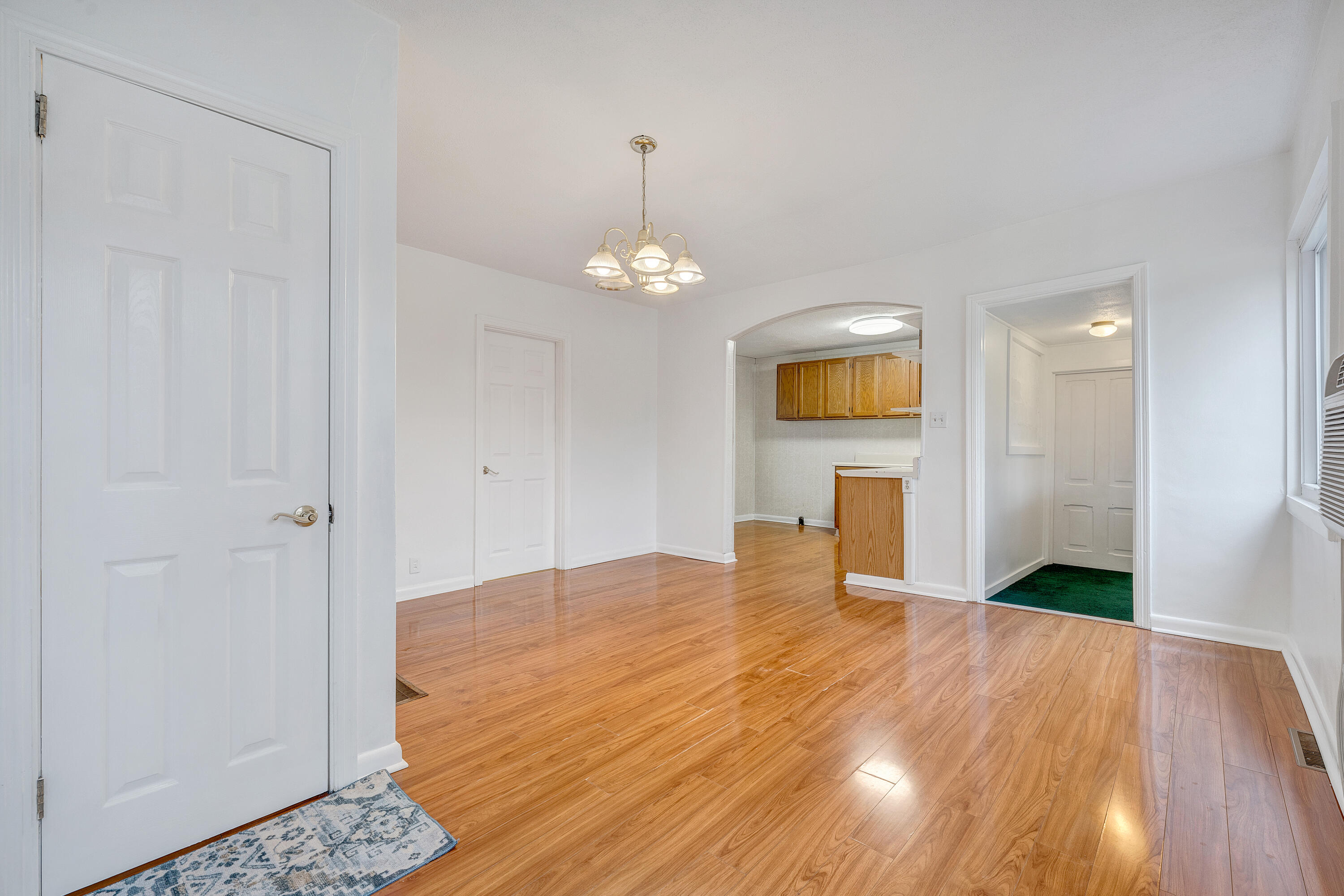 1115 Morgans Mill Road Goodview, VA 24095 - Photo 3 of 50 a bedroom with a bed and a chandelier