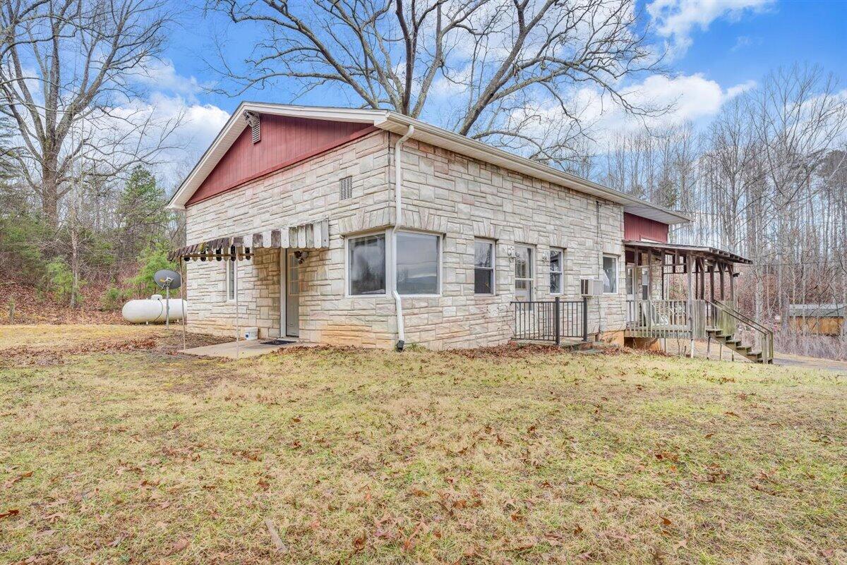 1115 Morgans Mill Road Goodview, VA 24095 - Photo 37 of 50 a white house that has a tree in front of it