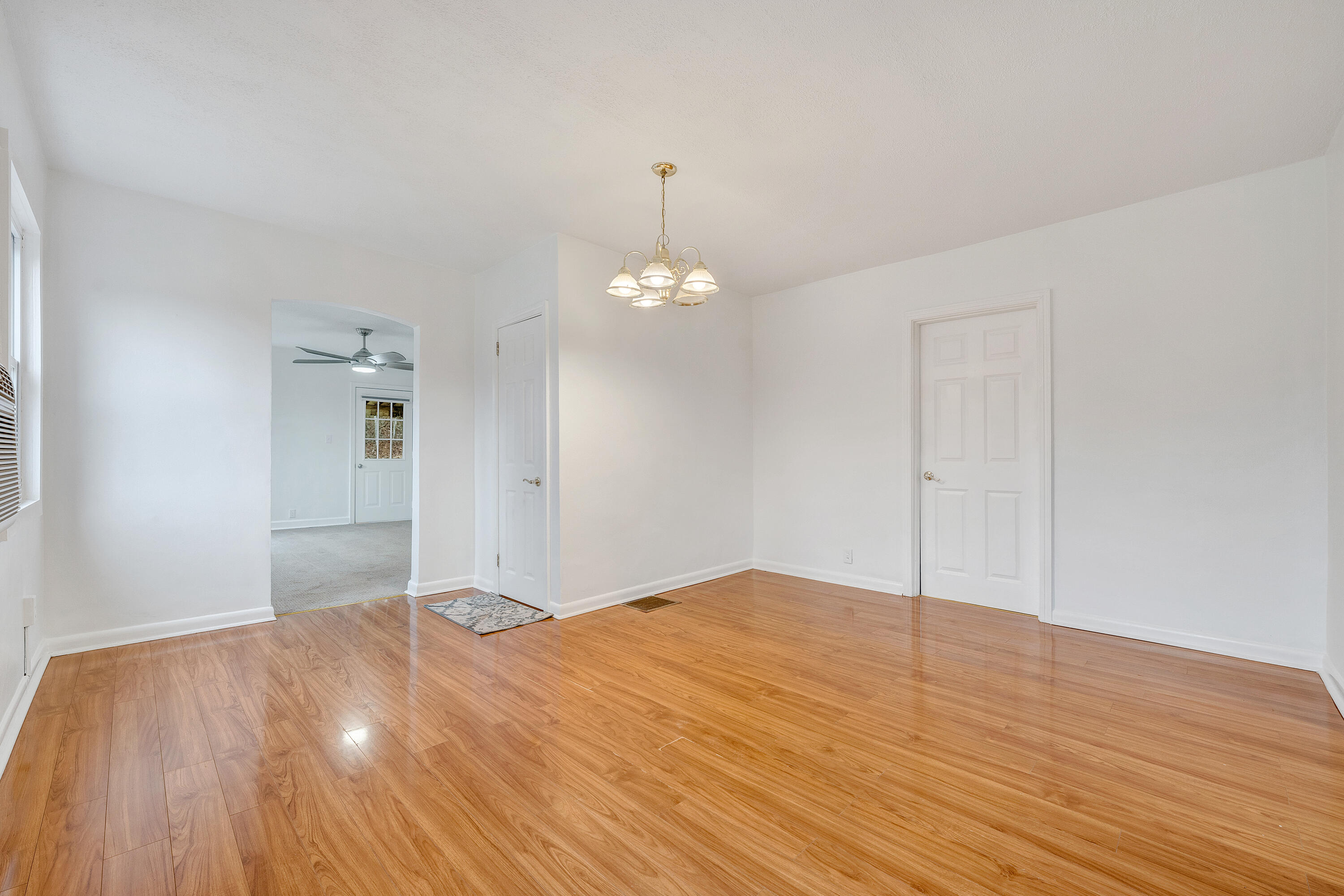 1115 Morgans Mill Road Goodview, VA 24095 - Photo 4 of 50 a bedroom with a bed and a chandelier