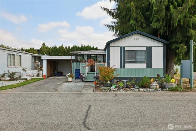 a front view of a house with a yard and outdoor seating