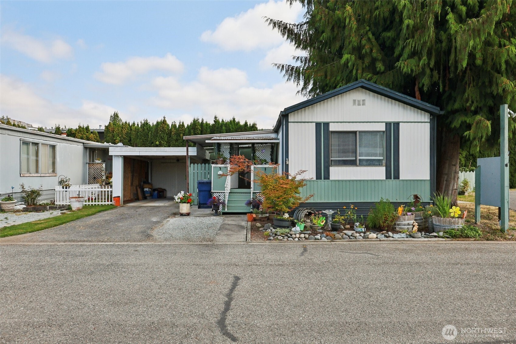 2522 Old Highway 99 South Road, Unit 19 Mount Vernon, WA 98273 - Photo 1 of 21 a front view of a house with a yard and outdoor seating
