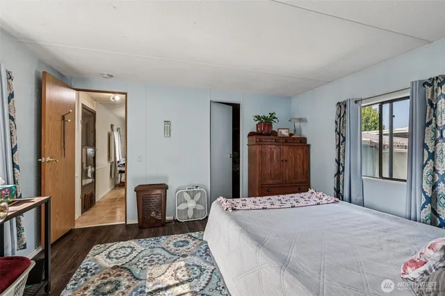 a bedroom with a large bed and a window