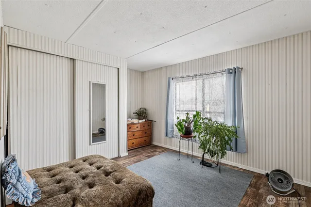 a bedroom with a bed and a potted plant
