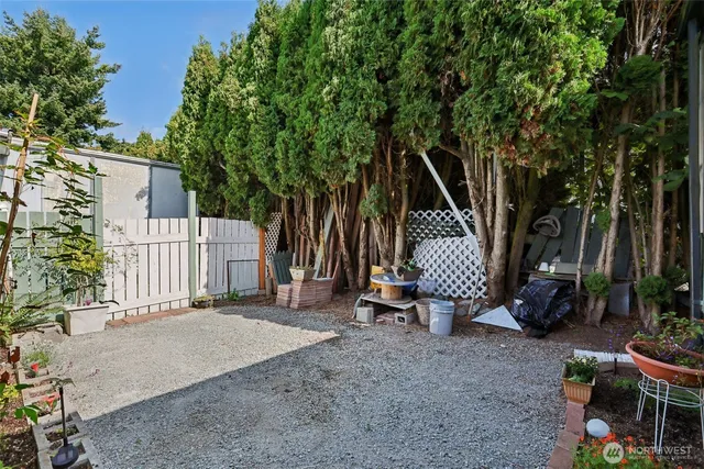 a view of a chair and table in the backyard