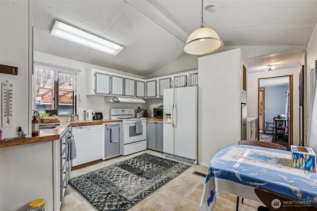 a kitchen with refrigerator and cabinets