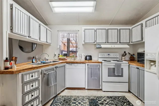 a kitchen with stainless steel appliances granite countertop a sink and cabinets