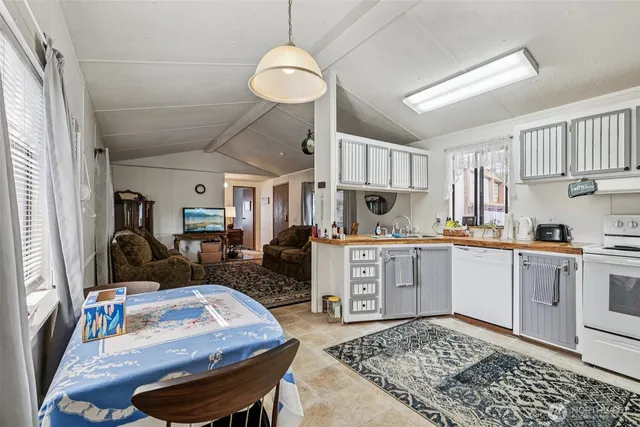 a kitchen with sink refrigerator and stove