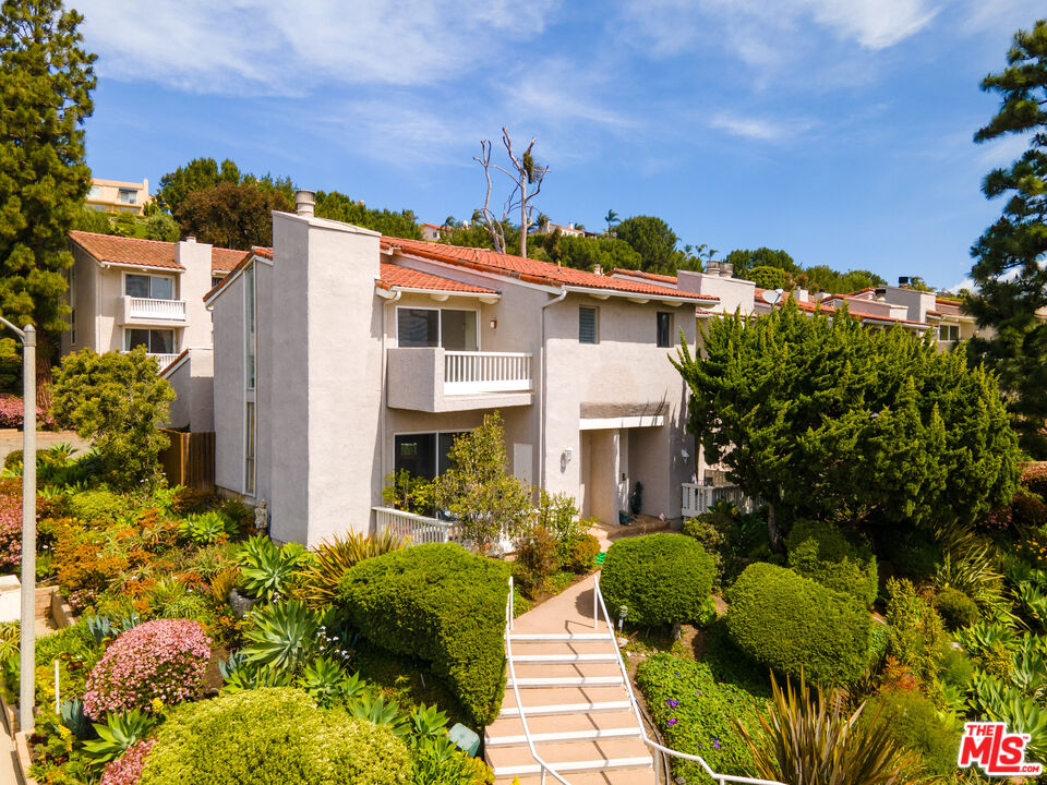 28288 Rey De Copas Lane Malibu, CA 90265 - Photo 14 of 44 a front view of a house with a yard