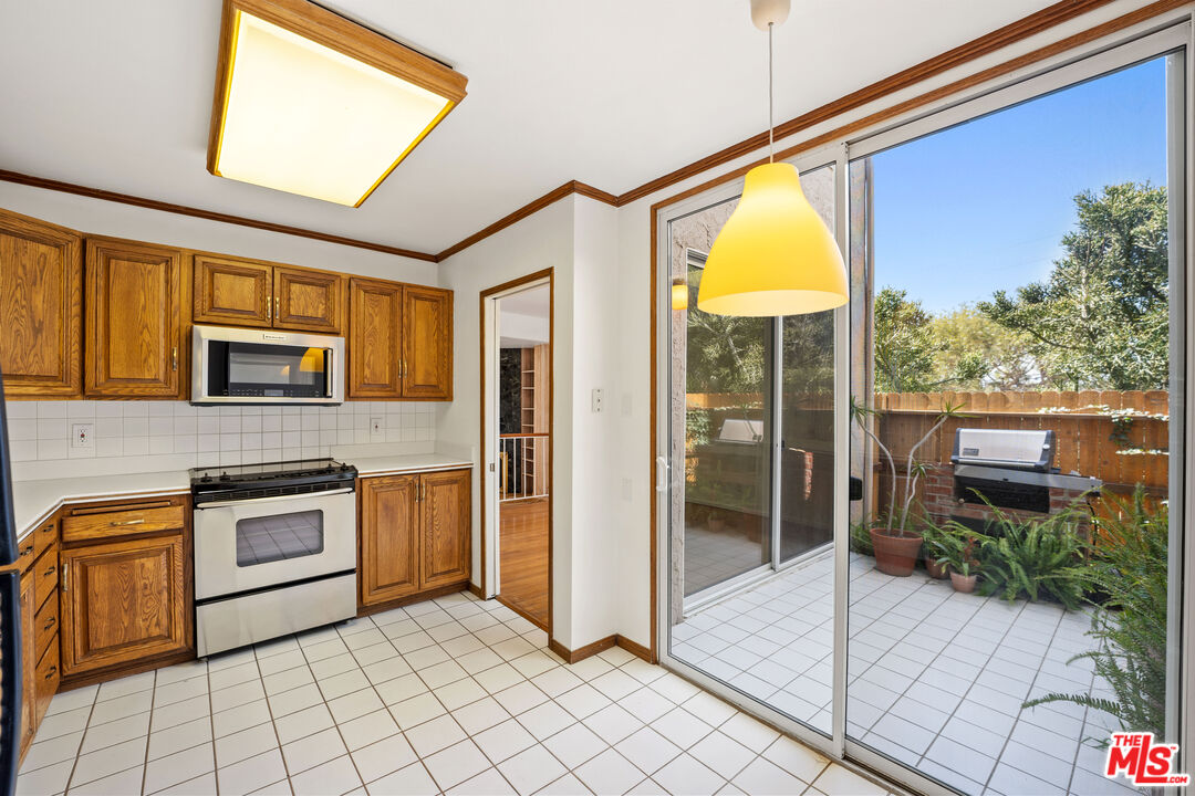 28288 Rey De Copas Lane Malibu, CA 90265 - Photo 20 of 44 a kitchen with stainless steel appliances granite countertop a refrigerator and a stove top oven