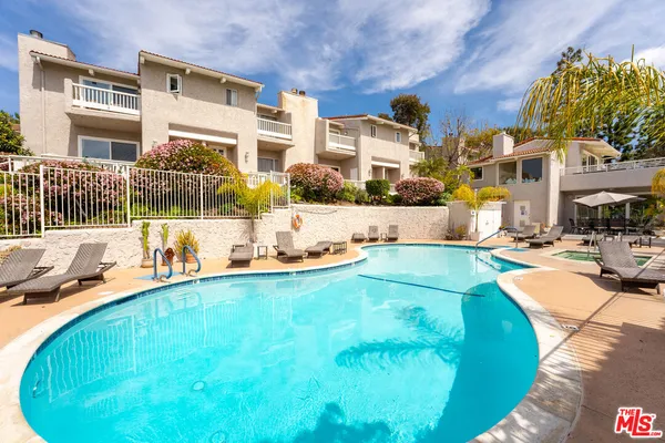 a view of a swimming pool with a patio