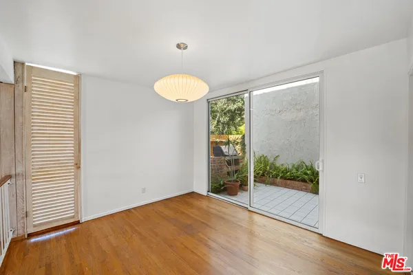 a view of a room with wooden floor and windows
