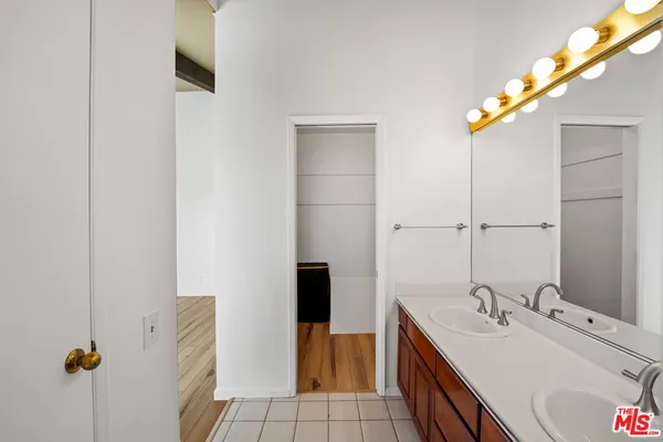 a bathroom with a sink vanity and a mirror