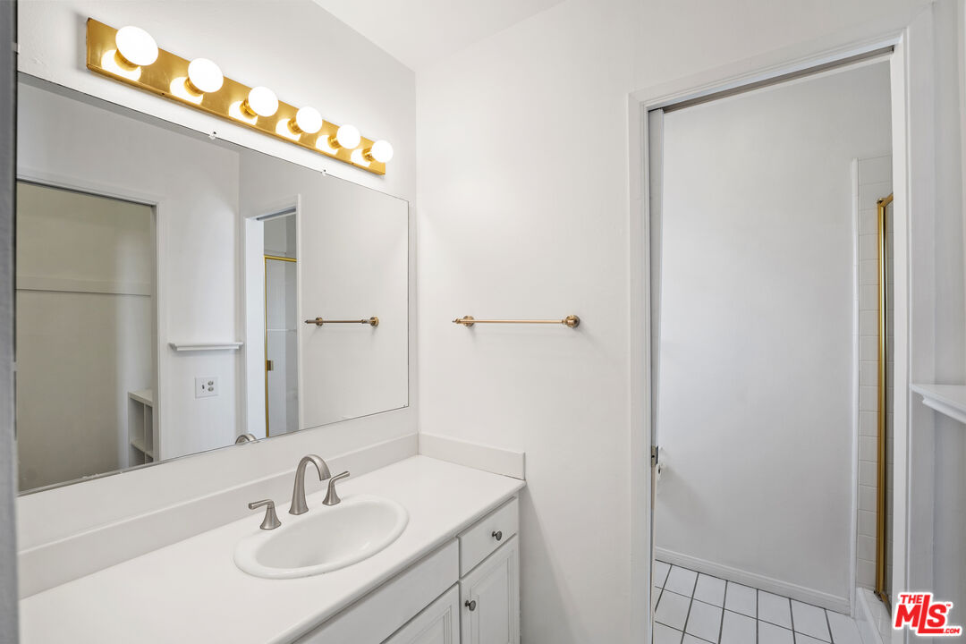 28288 Rey De Copas Lane Malibu, CA 90265 - Photo 37 of 44 a bathroom with a sink vanity and a mirror