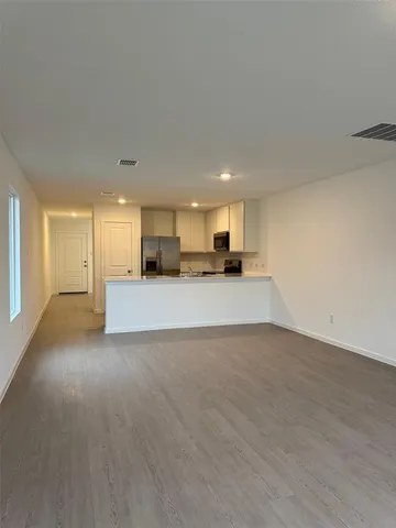 a view of a kitchen with a sink and a window