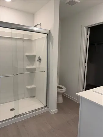 a bathroom with a shower and toilet