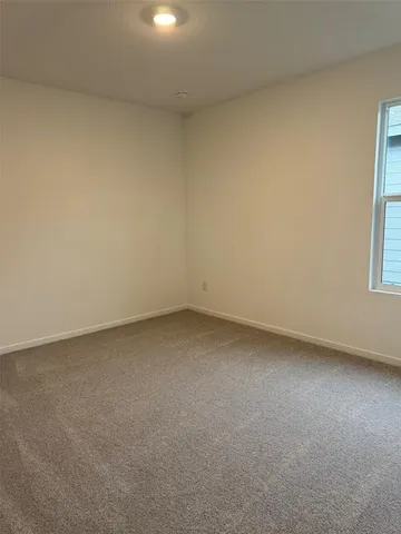 a view of an empty room and a window
