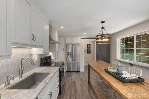 a kitchen with refrigerator cabinets and wooden floor