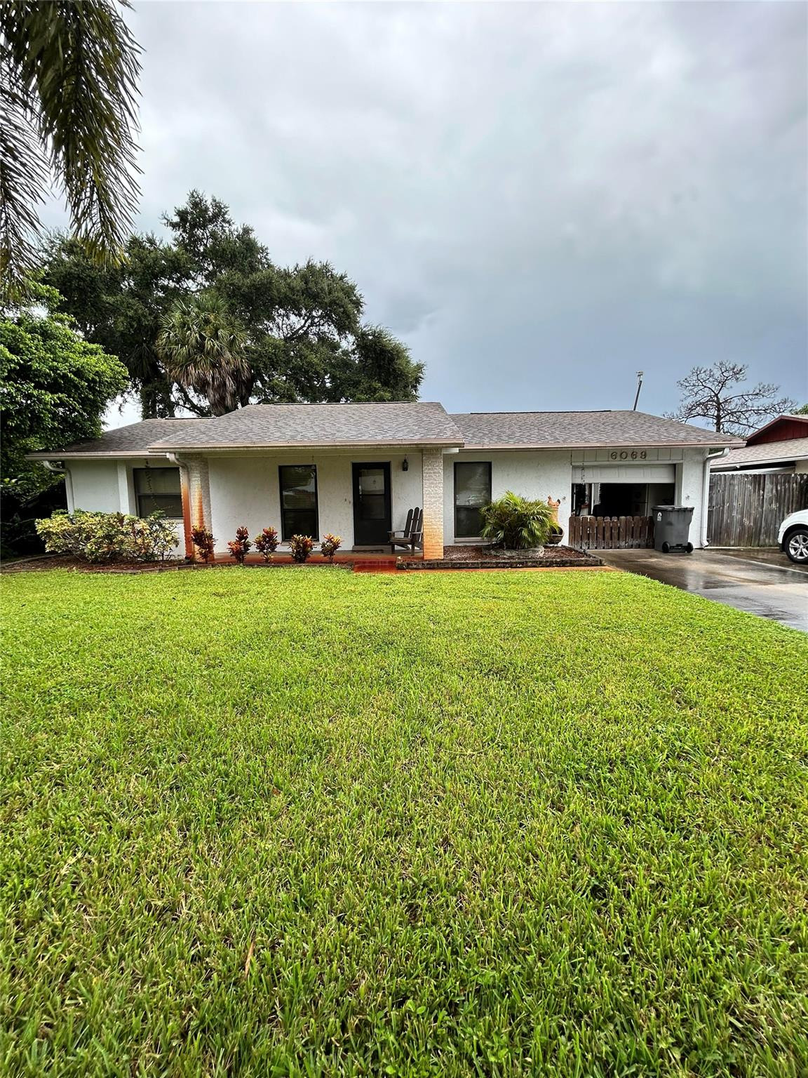 6069 Camp Lee Road West Palm Beach, FL 33417 - Photo 2 of 9 a view of house with a big yard and potted plants