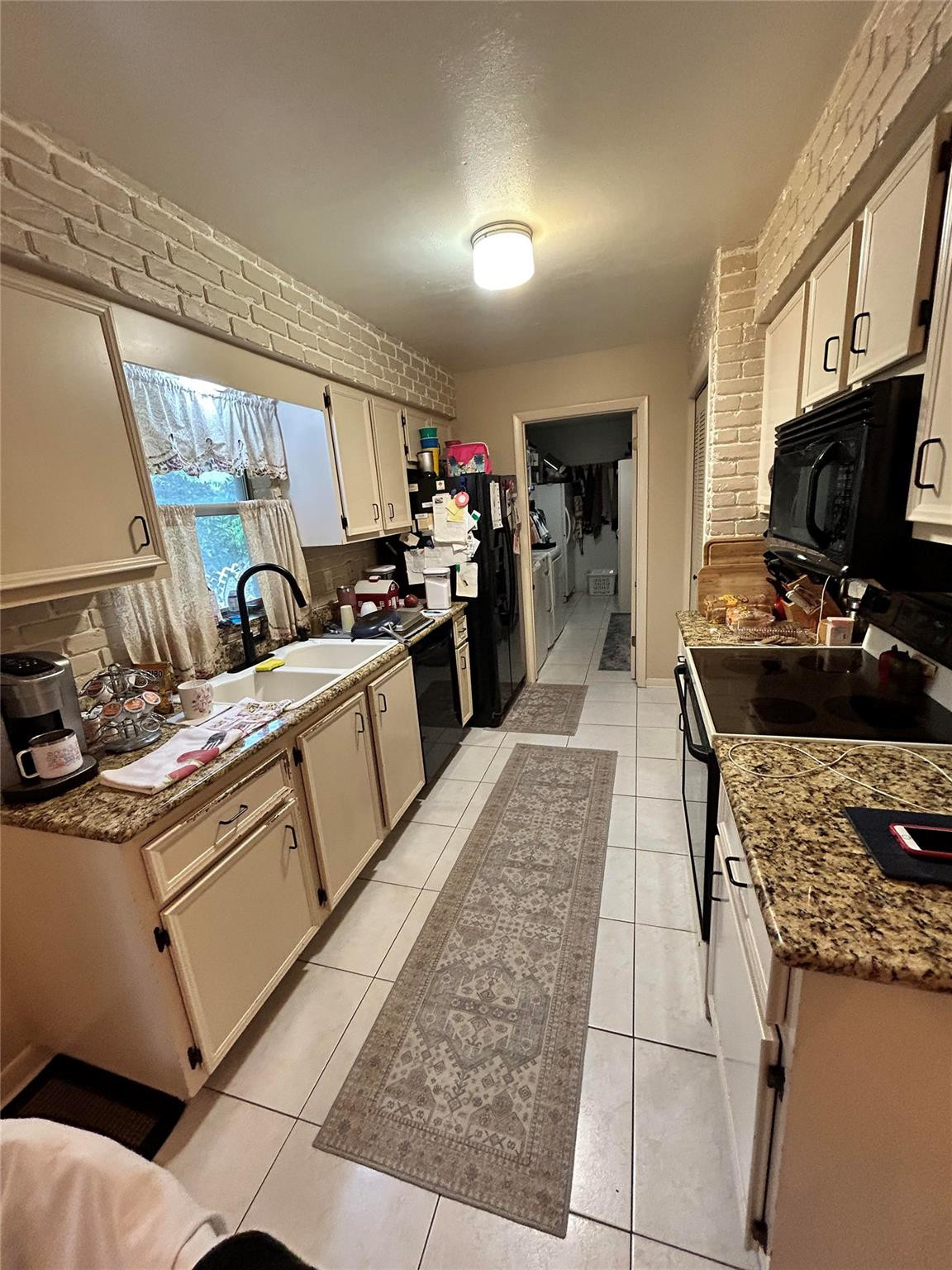 6069 Camp Lee Road West Palm Beach, FL 33417 - Photo 3 of 9 a kitchen with stainless steel appliances granite countertop a sink stove and refrigerator
