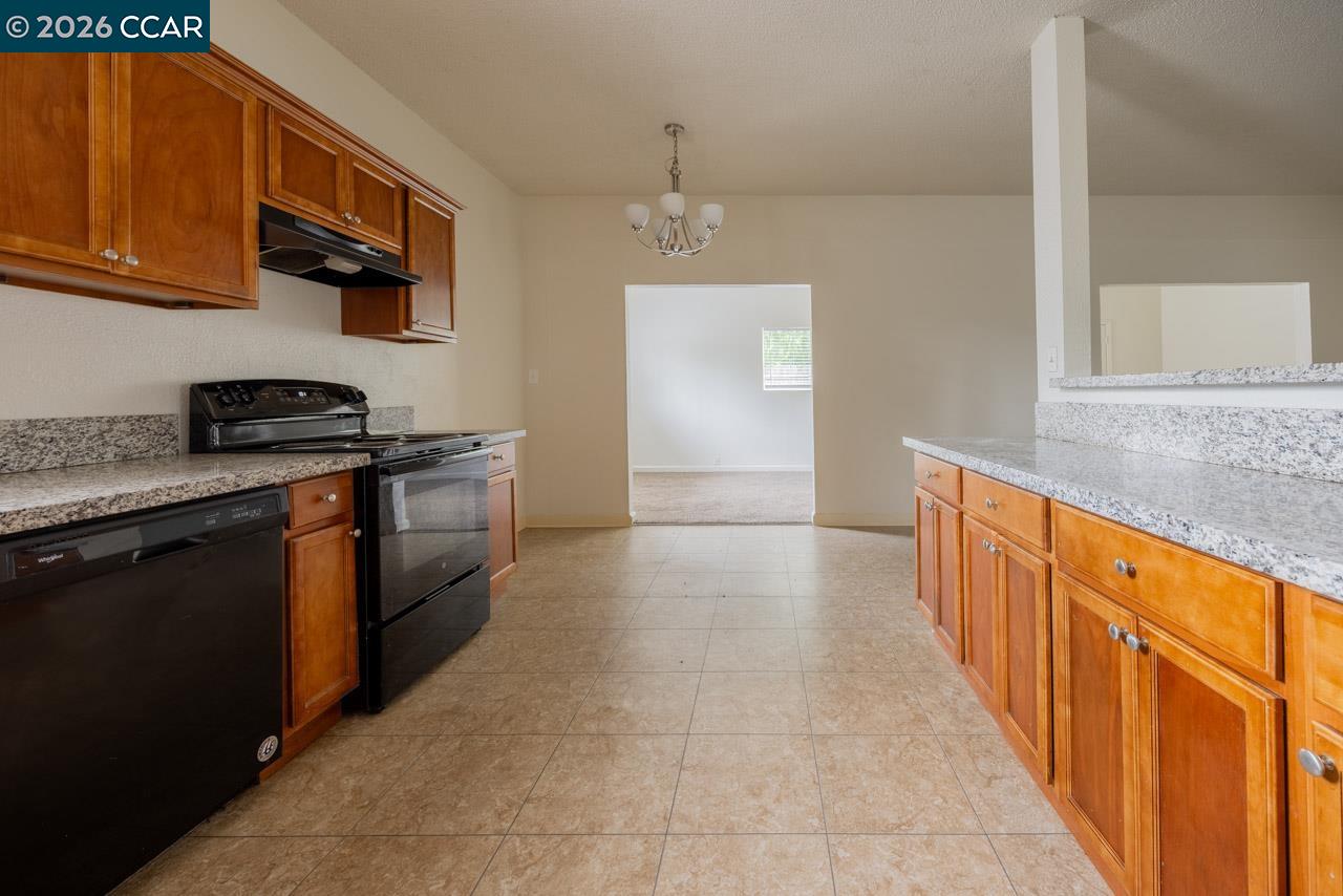 6118 Rutland Drive Carmichael, CA 95608 - Photo 6 of 19 a kitchen with stainless steel appliances granite countertop a stove a sink and a microwave