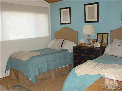 2101 Peninsula Road Oxnard, CA 93035 - Photo 21 of 28 a bedroom with a bed and a lamp on dresser