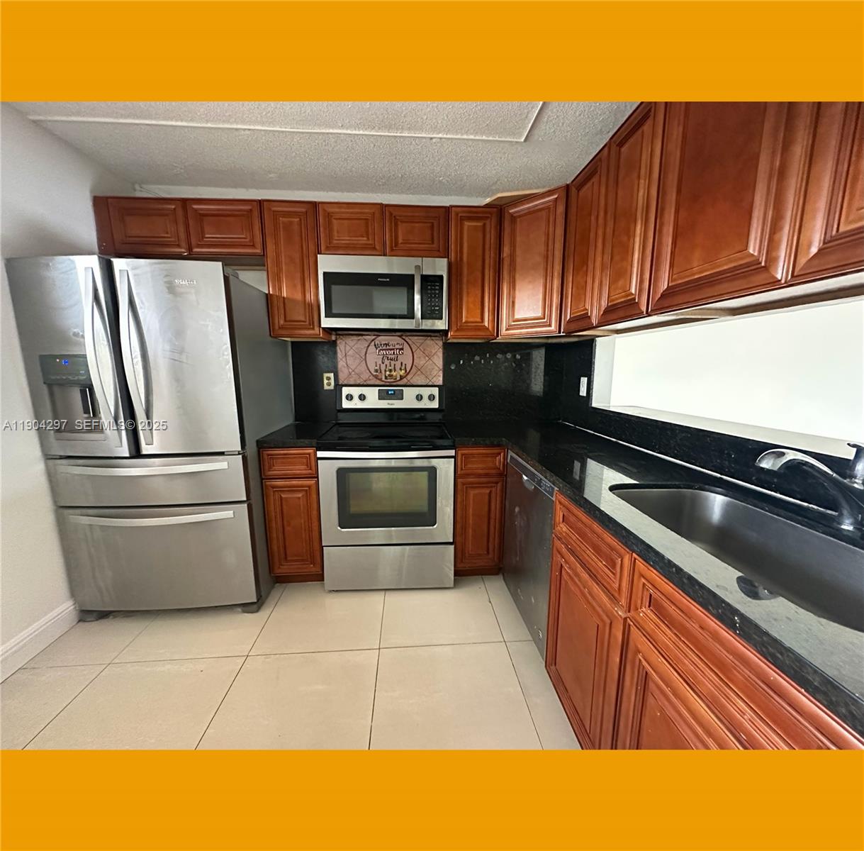 3396 Foxcroft Road, Unit 305 Miramar, FL 33025 - Photo 4 of 20 a kitchen with stainless steel appliances granite countertop a refrigerator and a stove top oven