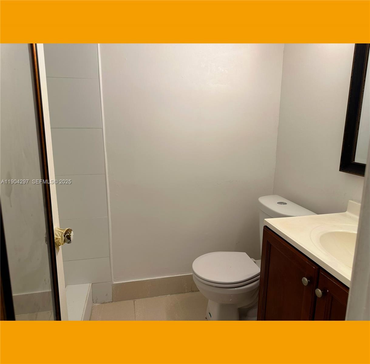 3396 Foxcroft Road, Unit 305 Miramar, FL 33025 - Photo 10 of 20 a bathroom with a sink a toilet and a mirror