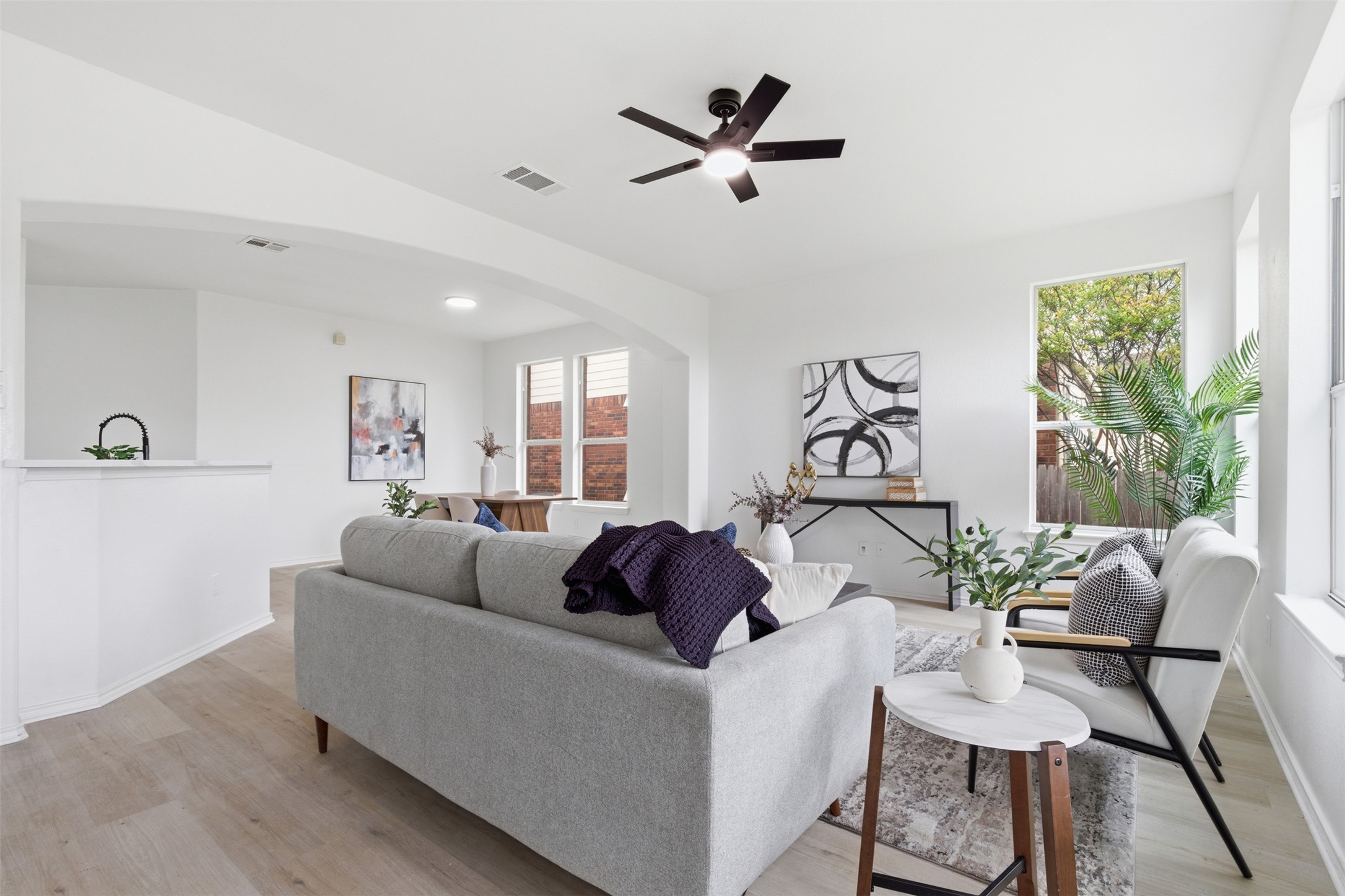 461 Hot Spring Valley Buda, TX 78610 - Photo 3 of 25 Living area featuring light-colored flooring, white walls, and a ceiling fan with integrated lighting