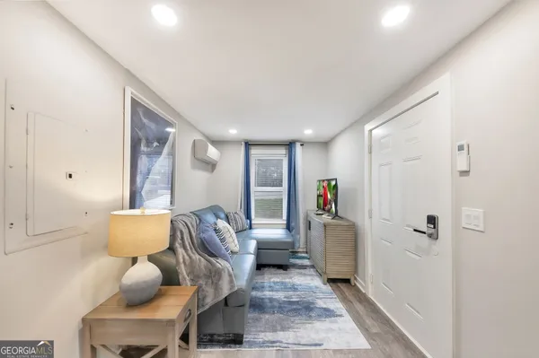 a hallway with a couch and chandelier