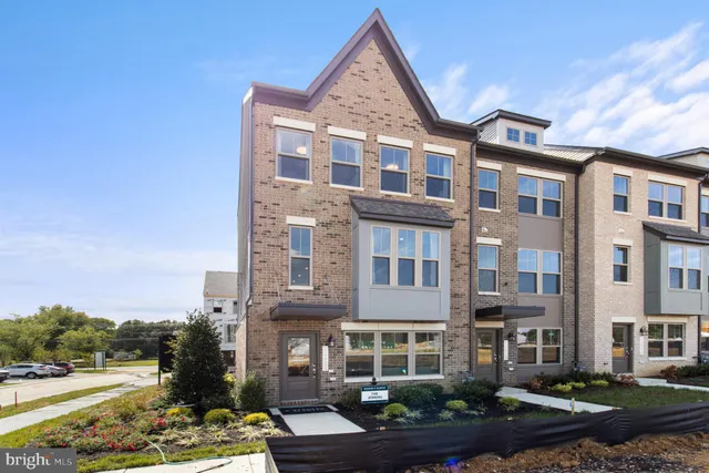 a front view of a residential apartment building with a yard