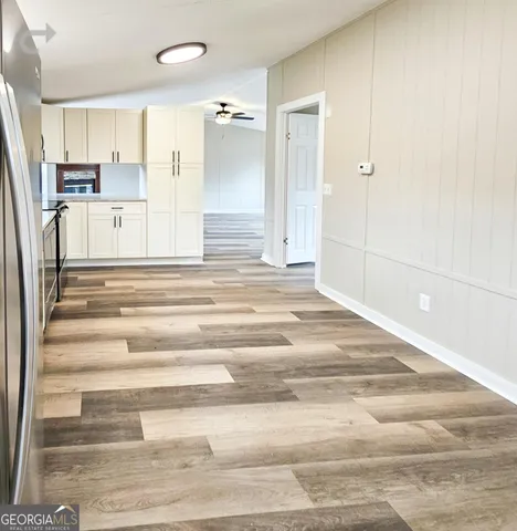 a view of a livingroom with a window and a ceiling fan