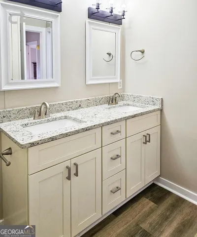 a bathroom with a granite countertop bathtub shower and toilet