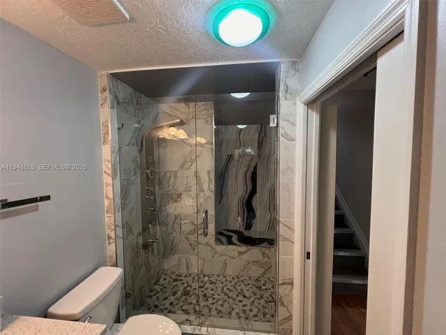 a view of a brick house with many windows and yard