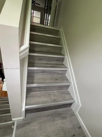 a view of a refrigerator in kitchen and wooden floor