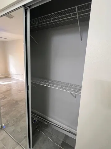 a view of backyard with a car parked in front of it