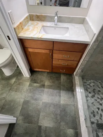 a view of a backyard with chairs and wooden fence