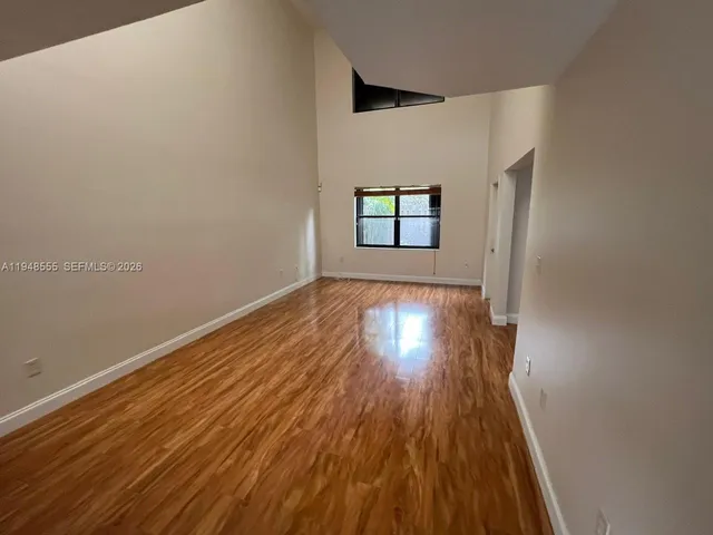 a view of a room with wooden floor