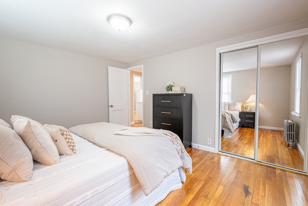 58 Gilman Street Springfield, MA 01118 - Photo 11 of 18 a bedroom with a bed and a view of en suite bathroom