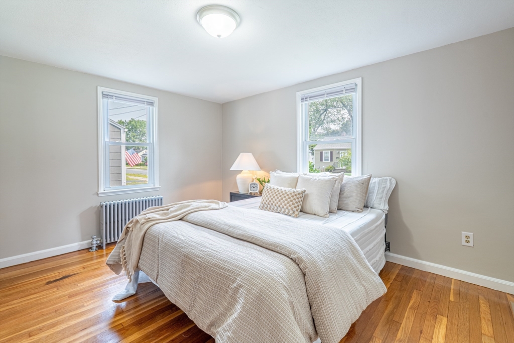 58 Gilman Street Springfield, MA 01118 - Photo 12 of 18 a bedroom with a bed and wooden floor