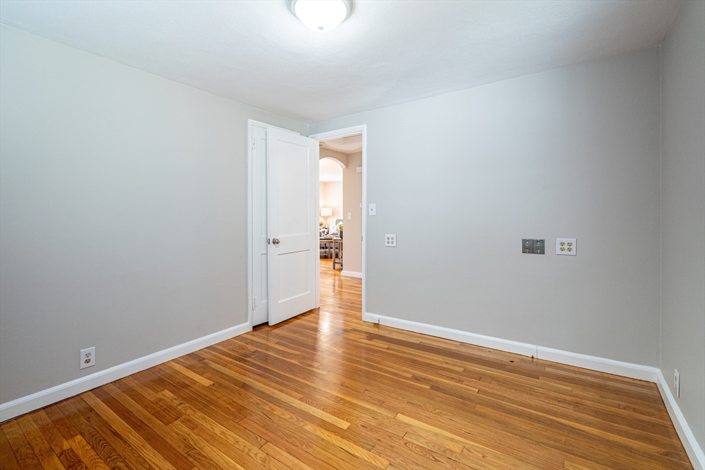 58 Gilman Street Springfield, MA 01118 - Photo 15 of 18 a view of an empty room with wooden floor