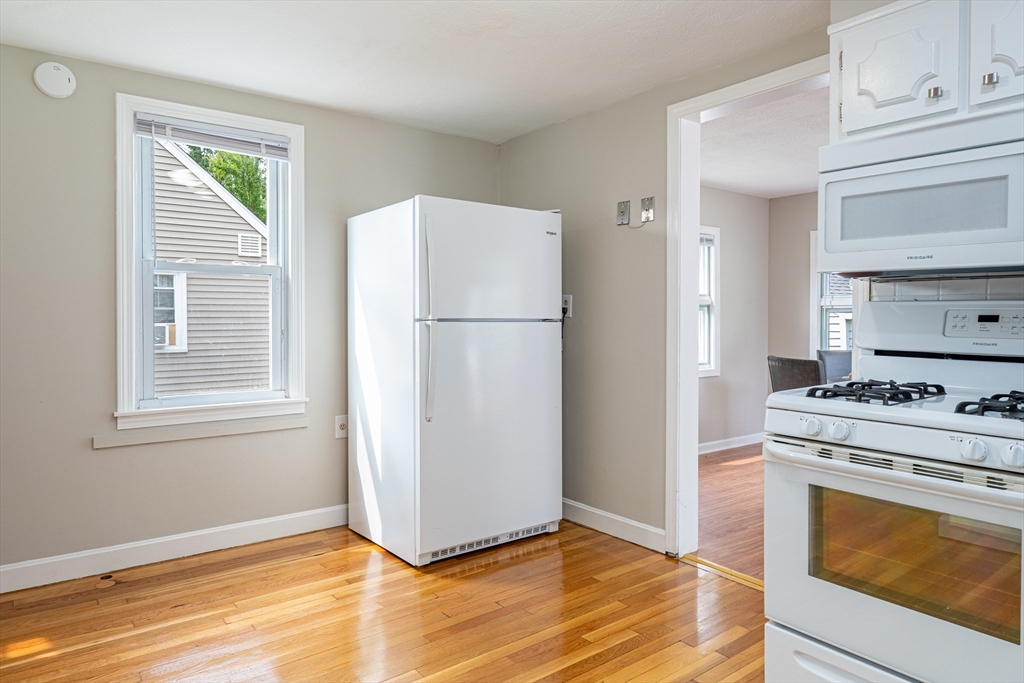 58 Gilman Street Springfield, MA 01118 - Photo 4 of 18 a kitchen with a refrigerator stove and sink