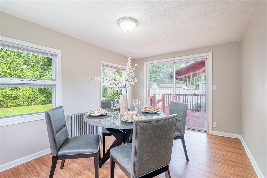 58 Gilman Street Springfield, MA 01118 - Photo 5 of 18 a dining room with furniture a rug and wooden floor