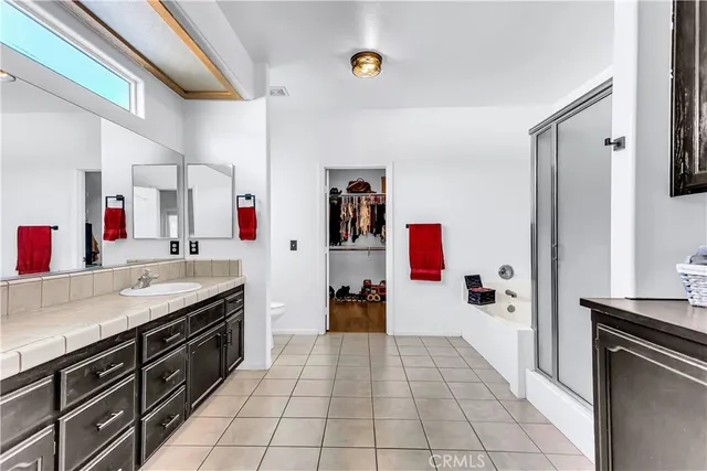 a bathroom with a granite countertop sink a toilet and a mirror