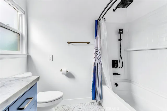 a view of a patio with table and chairs potted plants and large tree