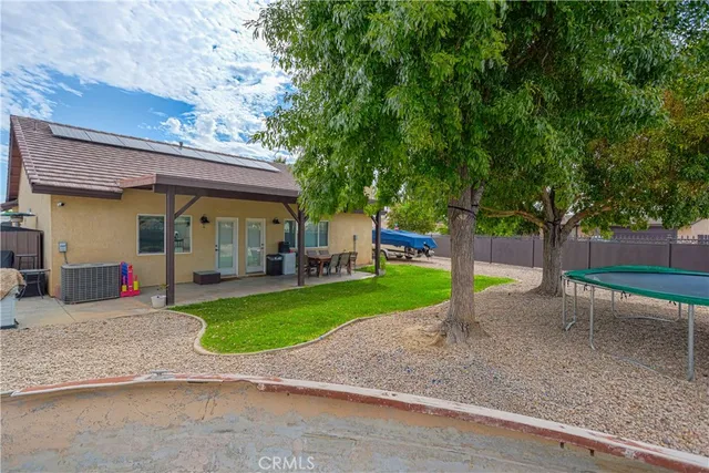 a backyard of a house with table and chairs