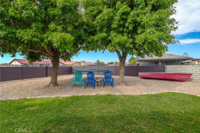 a view of a house with a backyard and sitting area