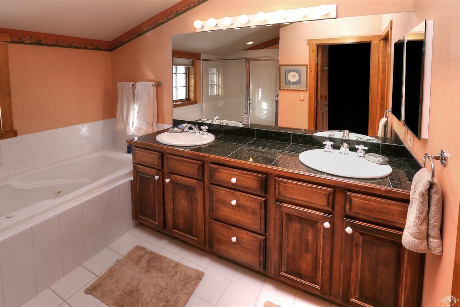 24 Clubhouse Circle Edwards, CO 81632 - Photo 8 of 17 a bathroom with a granite countertop sink a mirror and a bathtub