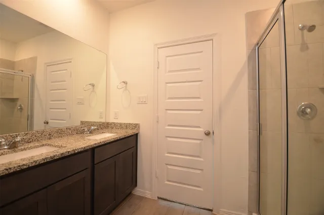 a bathroom with a granite countertop sink and a mirror